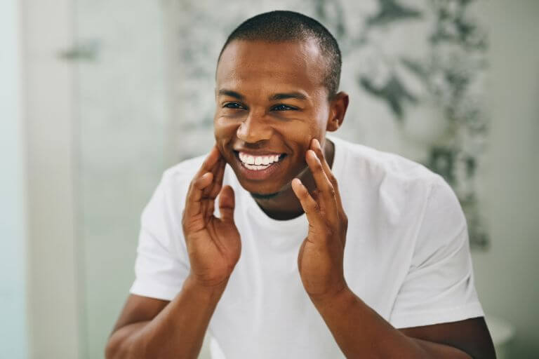 Man smiling with white teeth after teeth whitening